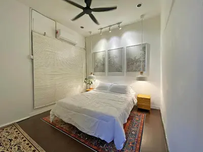 a bedroom with a bed and a ceiling fan at The Nook Holiday Home Cozy, Stylish, Swimming Pool in Ipoh
