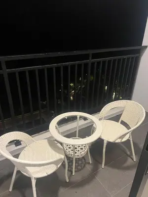 three chairs and a table on a balcony at The Cove 4-7 pax in Ipoh