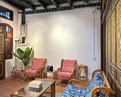 a group of chairs in a room with a table at Toh Aka Inn in George Town