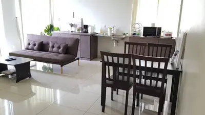 a living room with a couch and a table and chairs at The Haven Resort 3 rooms renovated suite in Tambun