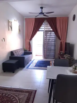 a living room with a couch and a ceiling fan at MK Homestay Sunway in Ipoh