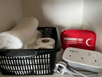 a basket with toilet paper and a red suitcase at Horizon Ipoh 8Pax 3R2B - Tropical Bird's Retreat in Ipoh