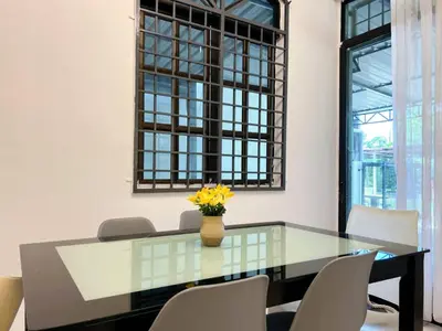 a glass table with a vase of yellow flowers on it at Vintage Comfort 3Bedroom Haus in Lunas