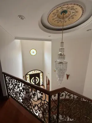 a staircase with a chandelier and a ceiling at Majestic Bungalow Seberang Jaya in Perai