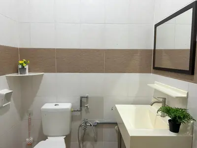 a bathroom with a white toilet and a sink at Life Art Home Family Ipoh Homestay 5R4B 18pax SY28 in Ipoh