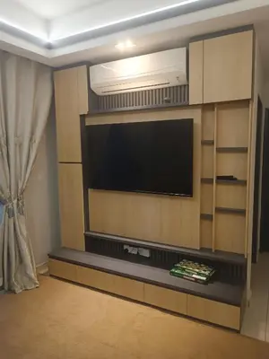 a living room with a flat screen tv on a wall at Airra Minimalist Suite-Ipoh Town in Ipoh