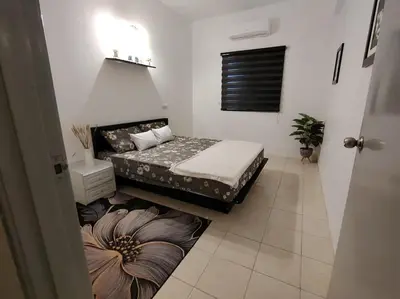 a small bedroom with two beds and a window at Firza Suite in Gua Sai