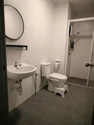 a bathroom with a sink and a toilet and a mirror at Nordic Haven \u5317\u6b27\u6696\u5c45 in Taiping