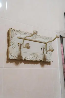 a shelf on the wall of a room at Villa Cinta Jasmeen in Kuala Kangsar