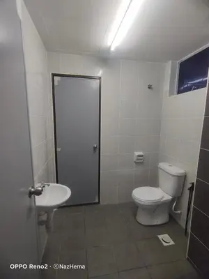 a bathroom with a toilet and a sink at NH Stay, Parit Buntar Perak in Parit Buntar