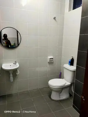 a bathroom with a toilet and a sink at NH Stay, Parit Buntar Perak in Parit Buntar