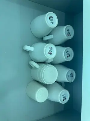 a bunch of white cups hanging on a wall at Southbay Seaview Condo A31 #10minQueensbay in Bayan Lepas
