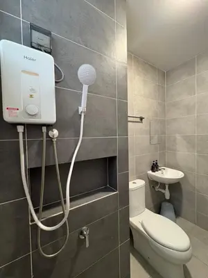 a shower in a bathroom with a toilet and a sink at Aston Acacia Homestay in Bukit Mertajam