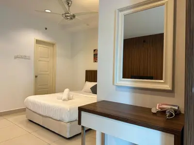 a bedroom with a bed with a mirror and a table at Mansion One Seaview Studio 4 pax Gurney in George Town