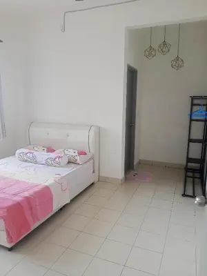 a white room with a bed and a ladder at Little sweet homestay in Ipoh