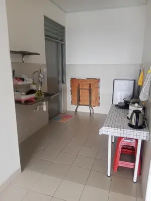 a kitchen with a table and a counter top at Little sweet homestay in Ipoh