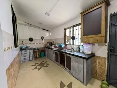 a large kitchen with a sink and a large window at Queen Bed Budget Room in Padang Serai