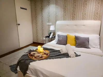 a bedroom with a bed with a tray of food on it at NEW 2BR Sunrise Gurney with Stunning Seaview \u65e0\u654c\u65e5\u51fa\u6d77\u666f\u623f in George Town