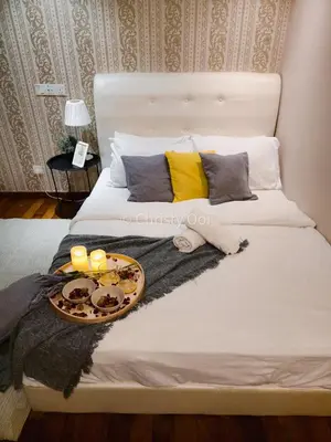 a bed with a tray of food and candles on it at NEW 2BR Sunrise Gurney with Stunning Seaview \u65e0\u654c\u65e5\u51fa\u6d77\u666f\u623f in George Town