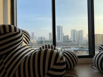 a room with two chairs in front of a window at Georgetown 2BR Luxury Condo Unbeatable Night View Infinity Pool Attractions Food Fully Equipped#148B in Bayan Lepas