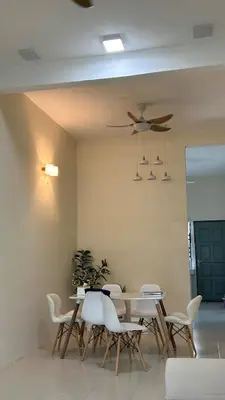 a dining room with a table and white chairs at Mimi's Nest - Fully furnished, wifi at Tronoh in Teronoh