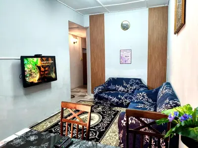 a living room with a couch and a tv at Homestay Bonda D' in TanjongMalim