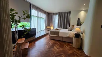 a bedroom with a bed and a large window at Room 11 by 10 Mentigi in Tanah Rata