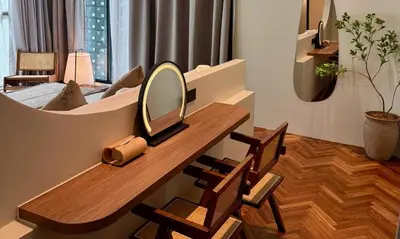 a dressing table with a mirror and chairs in a room at Room 11 by 10 Mentigi in Tanah Rata