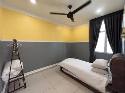 a bedroom with a bed and a ceiling fan at Palette & Pool Haven in Ipoh