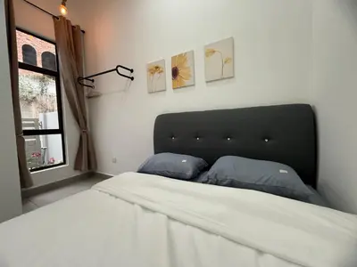 a bedroom with a bed with two pillows on it at 2 Storey Terrace 39 night market in Brinchang