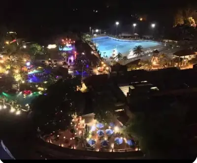 a view of a pool at night with lights at Sunway Onsen Theme Park View Ipoh in Ipoh