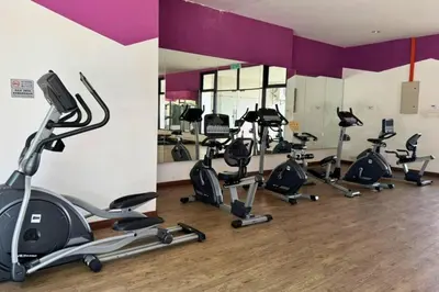 a gym with a bunch of exercise bikes in a room at Sunset View Stay at Conezion IOI in Gua Sai