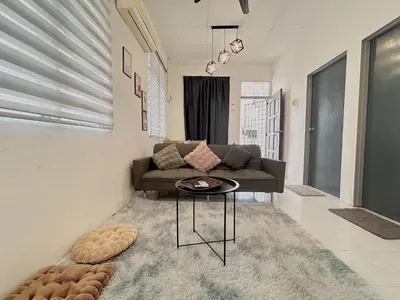 a living room with a couch and a table at 11Acozy#6pax#singlestoreyhouseAlmaBukitMertajam in Bukit Mertajam