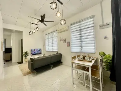 a living room with a couch and a table at 11Acozy#6pax#singlestoreyhouseAlmaBukitMertajam in Bukit Mertajam