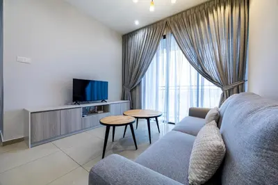 a living room with a couch and a tv at IconicRegency #3BR #USM #Queensbay #Airport in Bayan Lepas