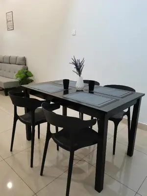 a black dining table with black chairs in a room at kkLee Homestay Taiping Tmn Spg Bersatu in Simpang