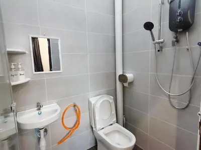 a bathroom with a shower and a toilet and a sink at kkLee Homestay Taiping Tmn Spg Bersatu in Simpang