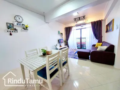 a living room with a table and a couch at RinduTamu Homestay in Lumut