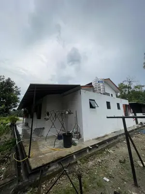 a house that is sitting on top of a wooden floor at Laman Serambi Homestay in Hutan Melintang