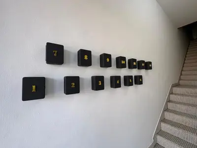 a wall with a bunch of black switches on a wall at Penang Miami Beach in Batu Ferringhi