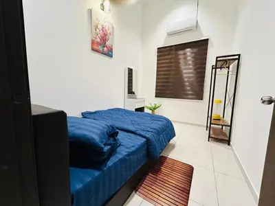 a bedroom with a blue bed and a window at Ethereal Ipoh Homestay in Ipoh