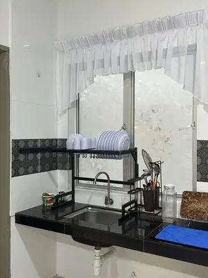 a kitchen counter with a sink and a window at Adik Aisyah cameron homestay quintet A3-7-5 in Tanah Rata