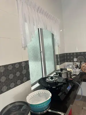 a kitchen with a stove and a bowl on the counter at Adik Aisyah cameron homestay quintet A3-7-7 in Tanah Rata