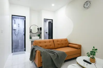 a living room with a couch and a mirror at Serene Nest Cameron Centrum Brinchang Clover Home A-1-15 B in Brinchang