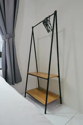 a shelf with a mirror on a wall next to a bed at Serene Nest Cameron Centrum Brinchang Clover Home A-1-15 B in Brinchang