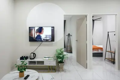 a living room with a tv on a white wall at Serene Nest Cameron Centrum Brinchang Clover Home A-1-15 B in Brinchang
