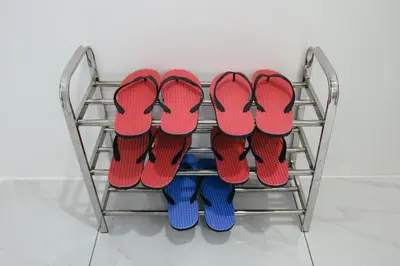 four pairs of shoes on a rack at Cameron Centrum Brinchang JoyStay Private Kids Playground Clover Home A-2-15 A in Brinchang