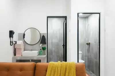 a living room with a couch and a mirror at Cameron Centrum Brinchang JoyStay Private Kids Playground Clover Home A-2-15 A in Brinchang