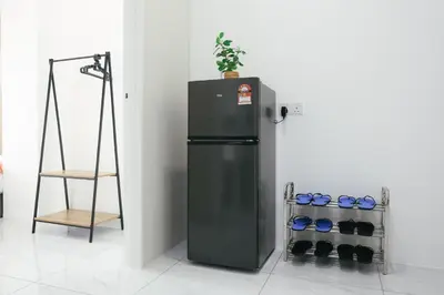 a black refrigerator in a room with a plant on top at Cameron Centrum Brinchang Breeze Cozy Retreat Clover Home A-2-15B in Brinchang
