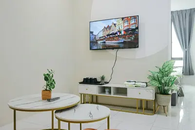 a living room with two tables and a tv on the wall at Cameron Centrum Brinchang ChillSuites Peaceful Escape Clover Home A-3-15B in Brinchang